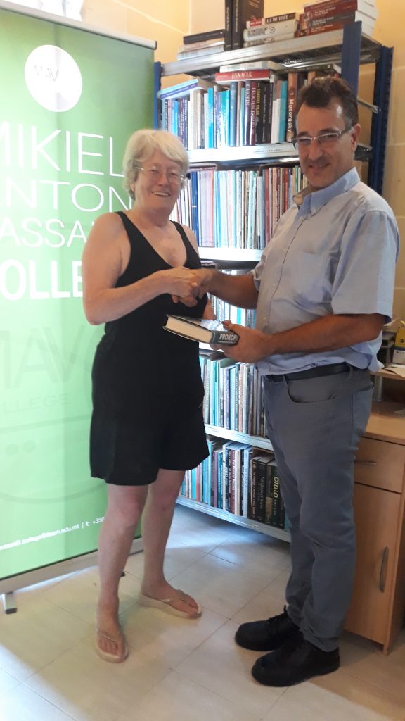 Ms Liz Groves donating music books to Mr Victor Galea